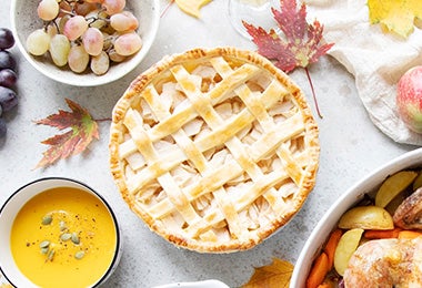 Mesa con preparaciones y pie postre con manzana