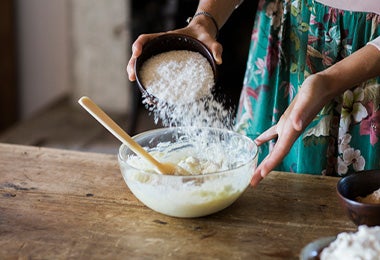  Una mujer preparando la masa de un pan sin gluten.