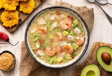 Plato de caldo de pescado con camarones, ajíes, plátano y aguacate  