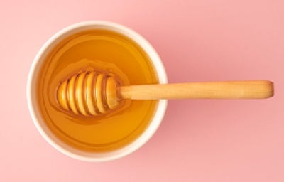 Recipiente con miel de abejas Recipiente con miel de abejas